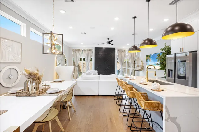a living room with kitchen island furniture and a chandelier