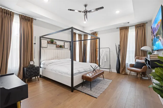 a bedroom with a bed couch and a window