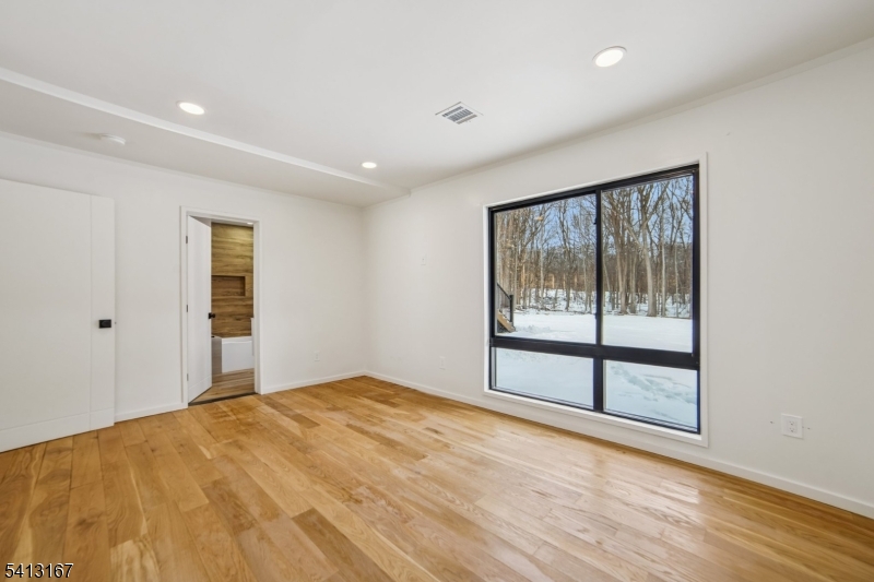 156 Park Road Parsippany, NJ 07054 - Photo 34 of 44 a view of an empty room with wooden floor and a window