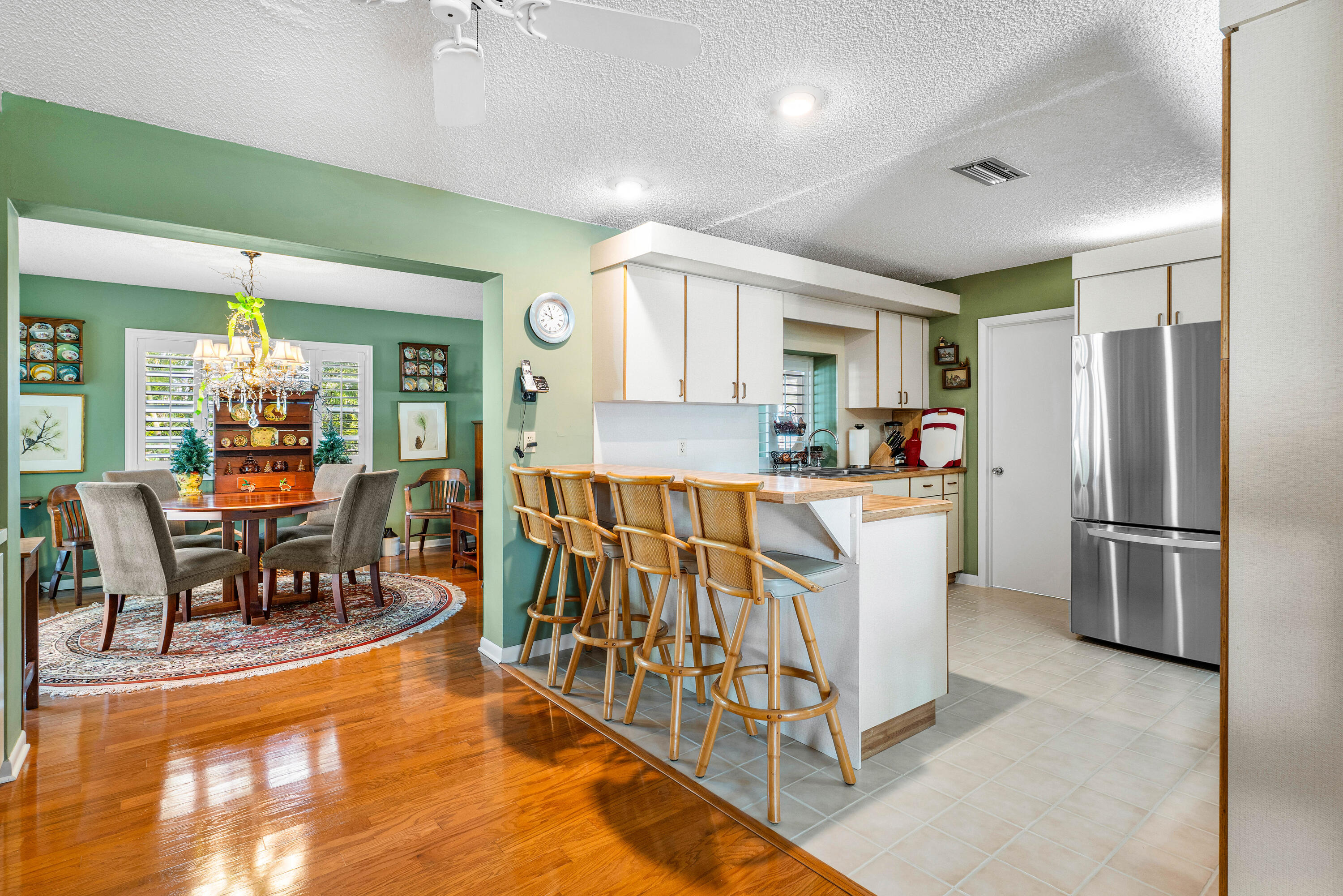 1210 Dolphin Road Singer Island, FL 33404 - Photo 12 of 41 a kitchen with stainless steel appliances kitchen island granite countertop a refrigerator and a stove