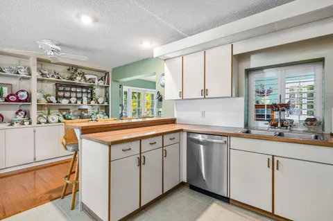 a kitchen with sink cabinets and wooden floor