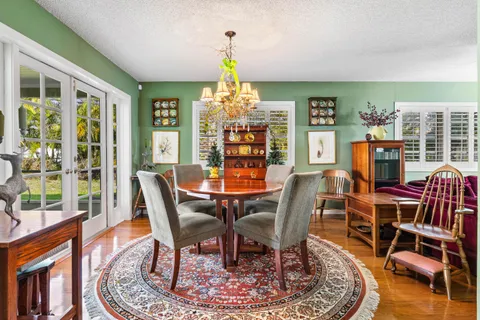 a dining room with furniture a rug and wooden floor