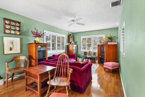 a living room with furniture a window and flat screen tv
