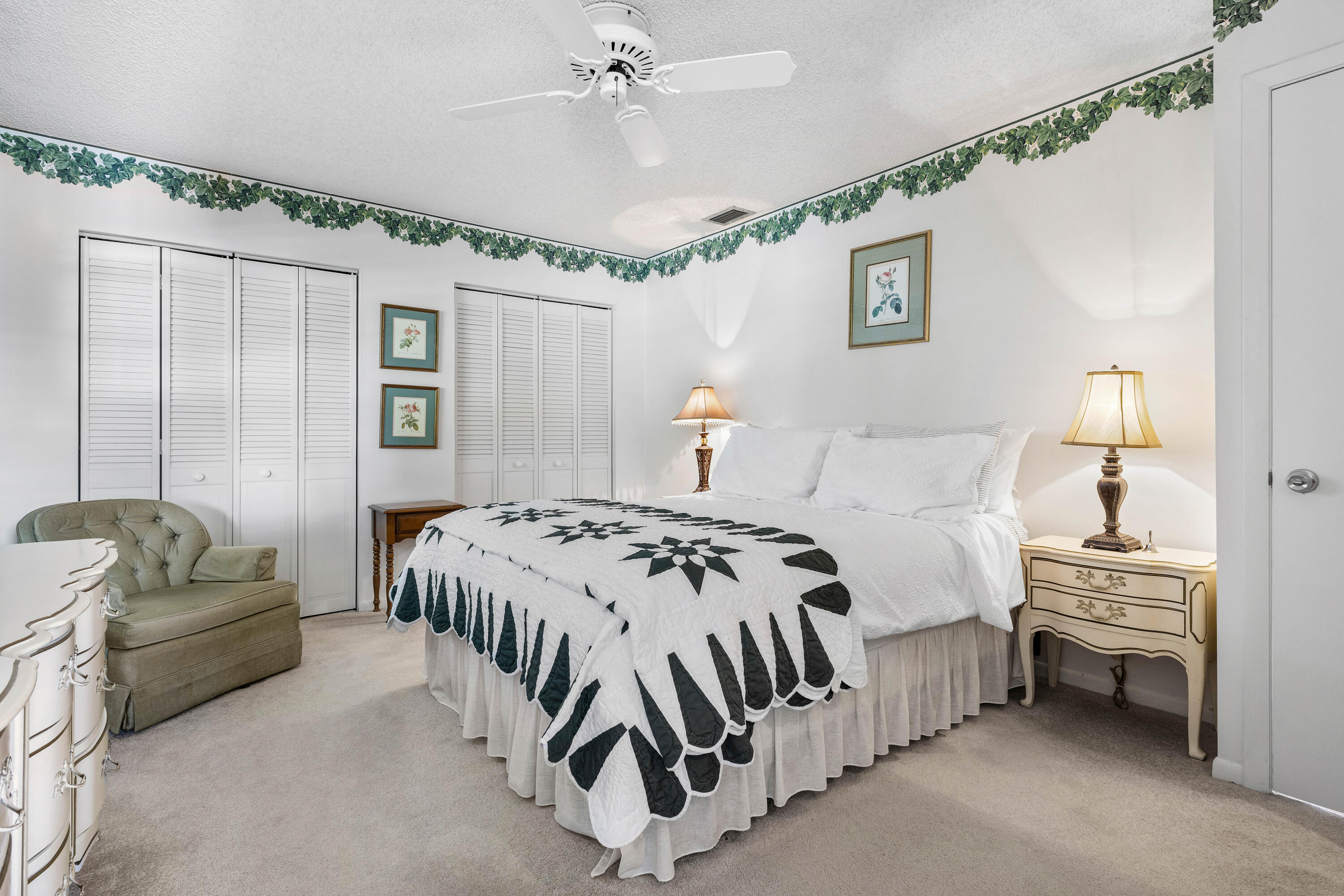 1210 Dolphin Road Singer Island, FL 33404 - Photo 27 of 41 a bedroom with a bed bed and a chandelier