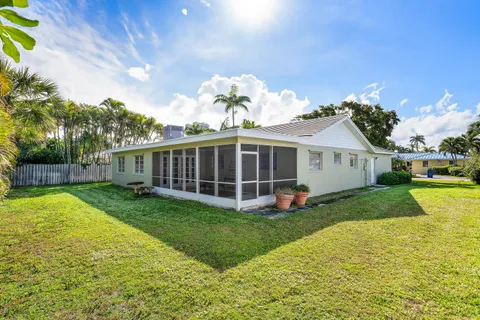 a view of a house with a yard and deck