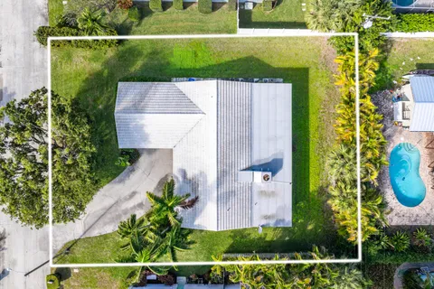 an aerial view of a house with a yard
