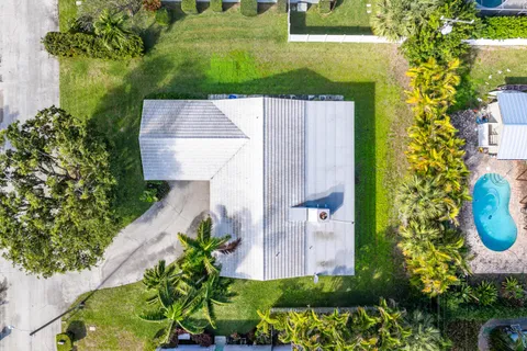 an aerial view of a house with a yard
