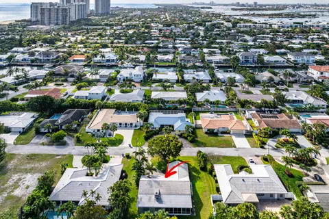 an aerial view of residential houses with outdoor space and parking