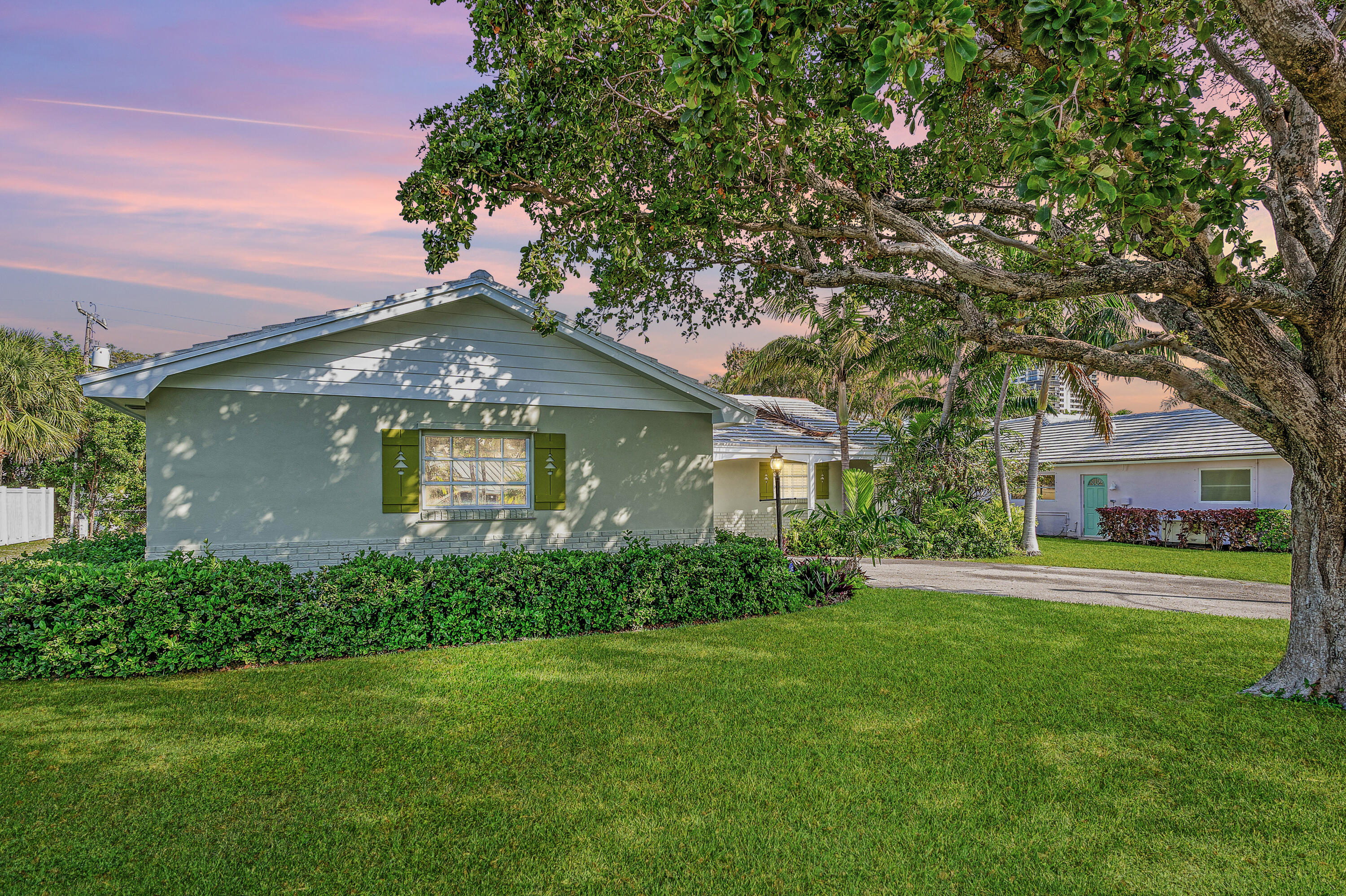 1210 Dolphin Road Singer Island, FL 33404 - Photo 39 of 41 a front view of a house with a garden