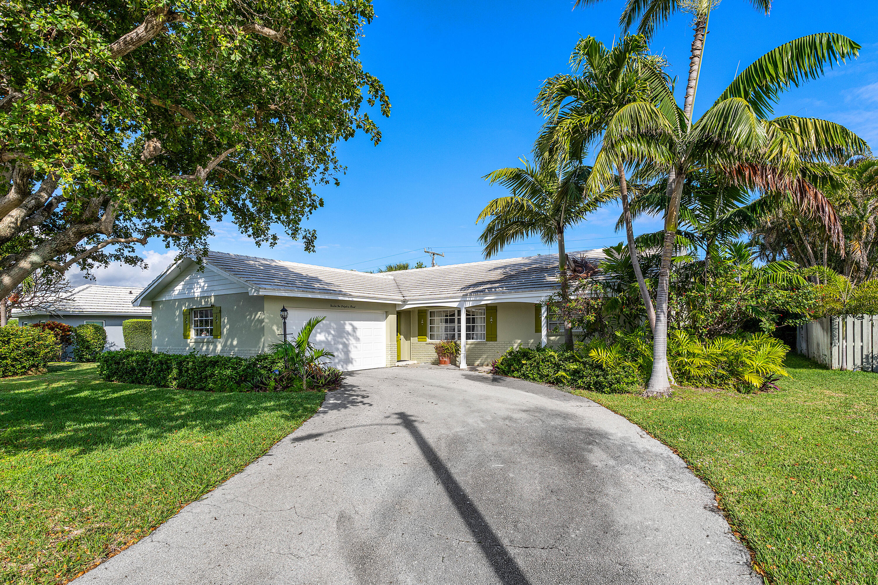 1210 Dolphin Road Singer Island, FL 33404 - Photo 7 of 41 a front view of a house with a garden