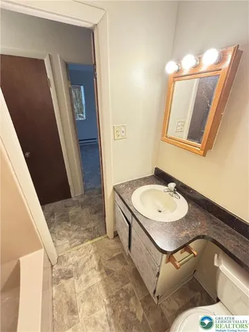 a bathroom with a sink and mirror