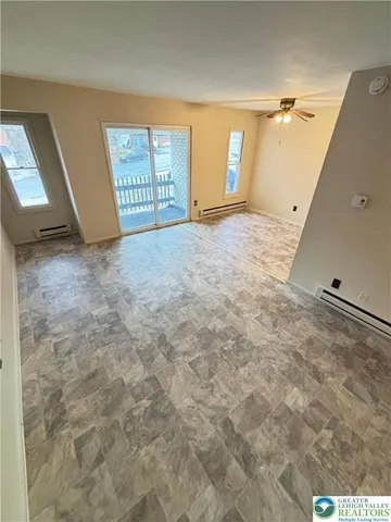 a view of an empty room with windows