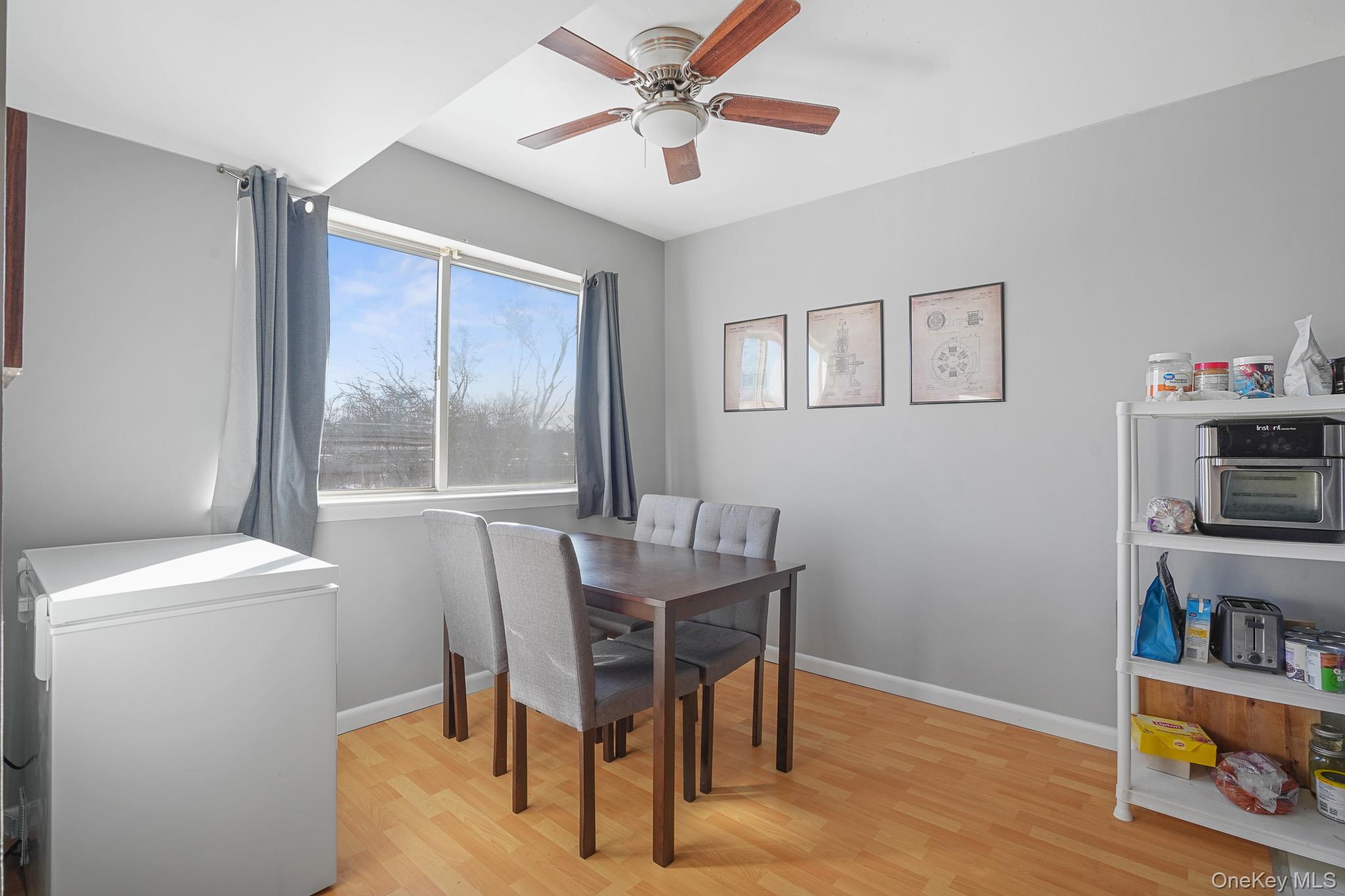 26 Cooper Road, Unit 411 Poughkeepsie, NY 12603 - Photo 11 of 17 Dining room with light wood-type flooring and ceiling fan