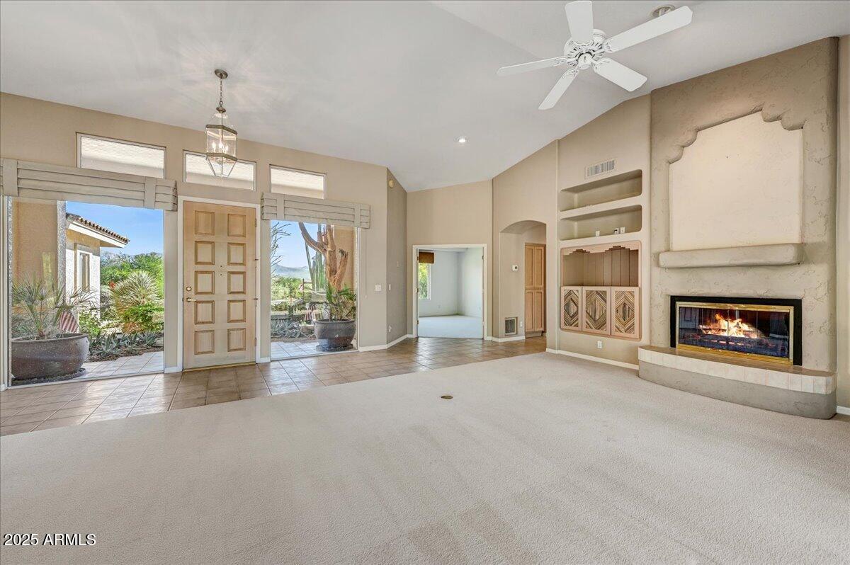 27002 North Agua Verde Drive Rio Verde, AZ 85263 - Photo 11 of 28 a view of an empty room with a fireplace and a window
