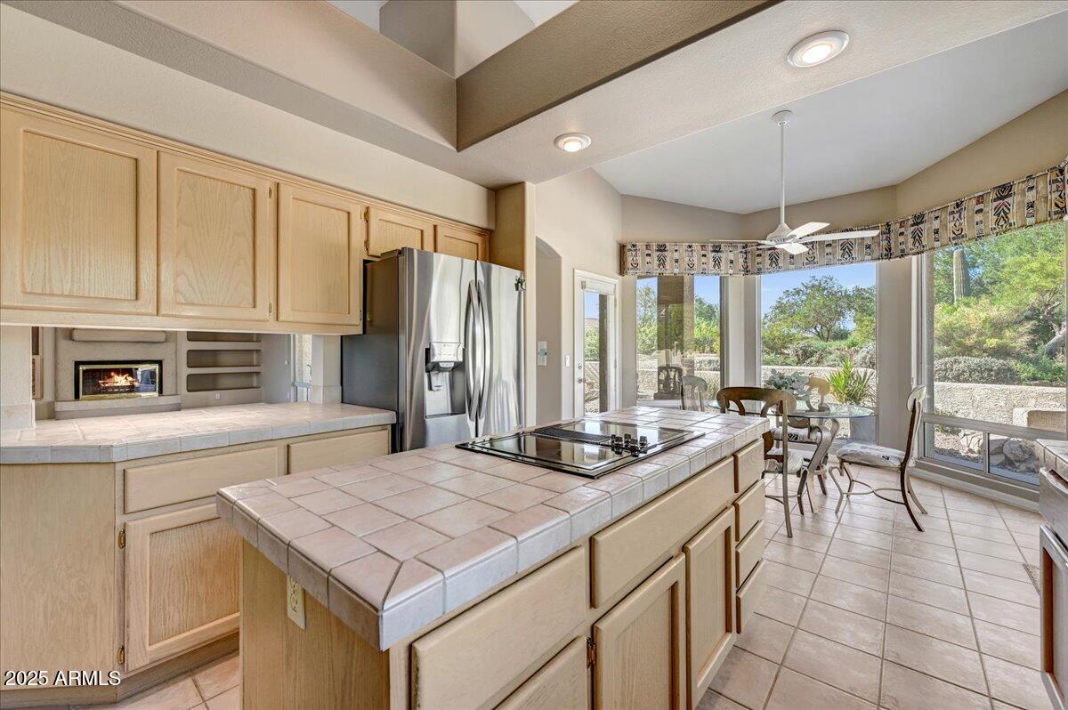 27002 North Agua Verde Drive Rio Verde, AZ 85263 - Photo 14 of 28 a kitchen with stainless steel appliances granite countertop a stove a refrigerator a sink and white cabinets with wooden floors