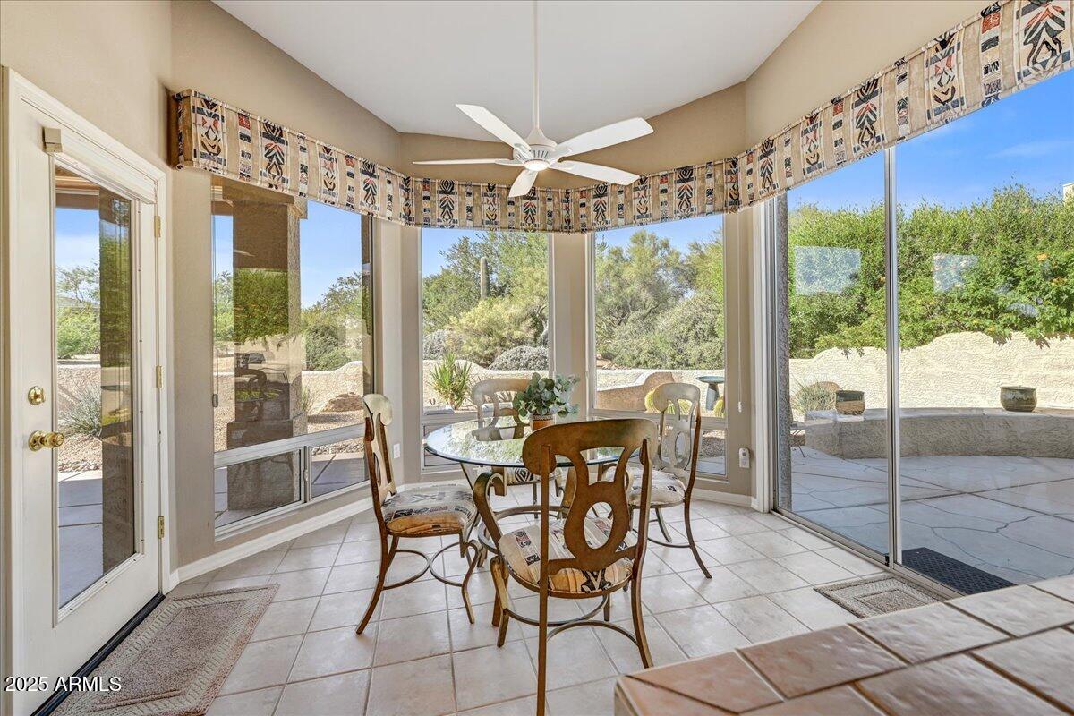 27002 North Agua Verde Drive Rio Verde, AZ 85263 - Photo 15 of 28 a dining room with furniture a chandelier and glass door