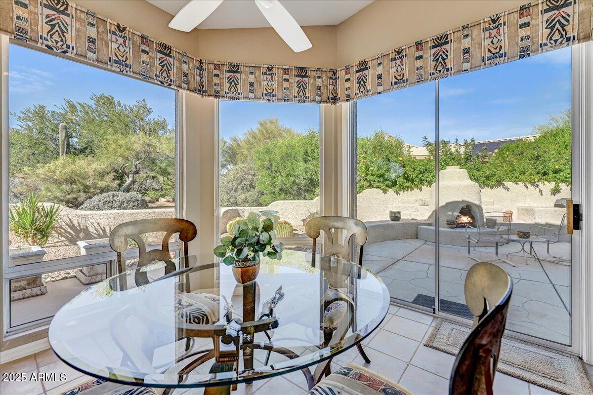 27002 North Agua Verde Drive Rio Verde, AZ 85263 - Photo 16 of 28 a dining room with furniture a rug and a chandelier