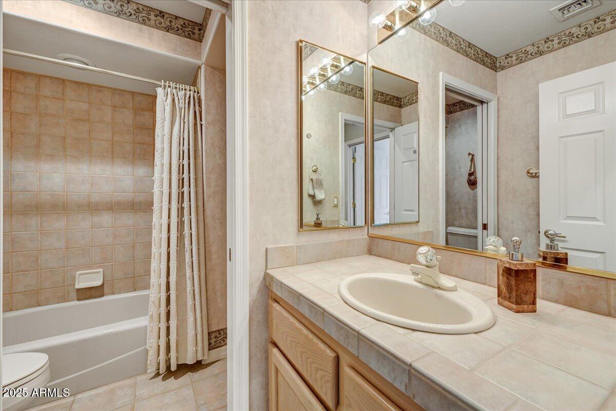 27002 North Agua Verde Drive Rio Verde, AZ 85263 - Photo 22 of 28 a bathroom with a sink and a mirror