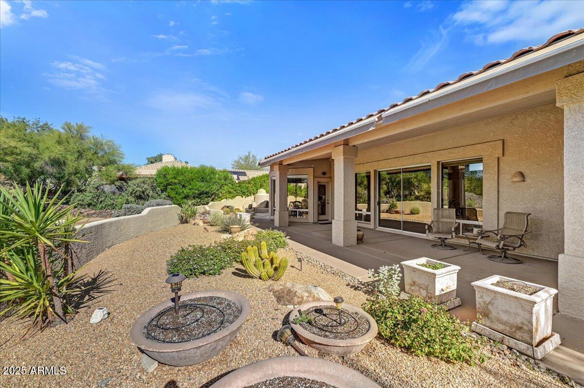 27002 North Agua Verde Drive Rio Verde, AZ 85263 - Photo 26 of 28 a view of a patio with couches table and chairs and potted plants