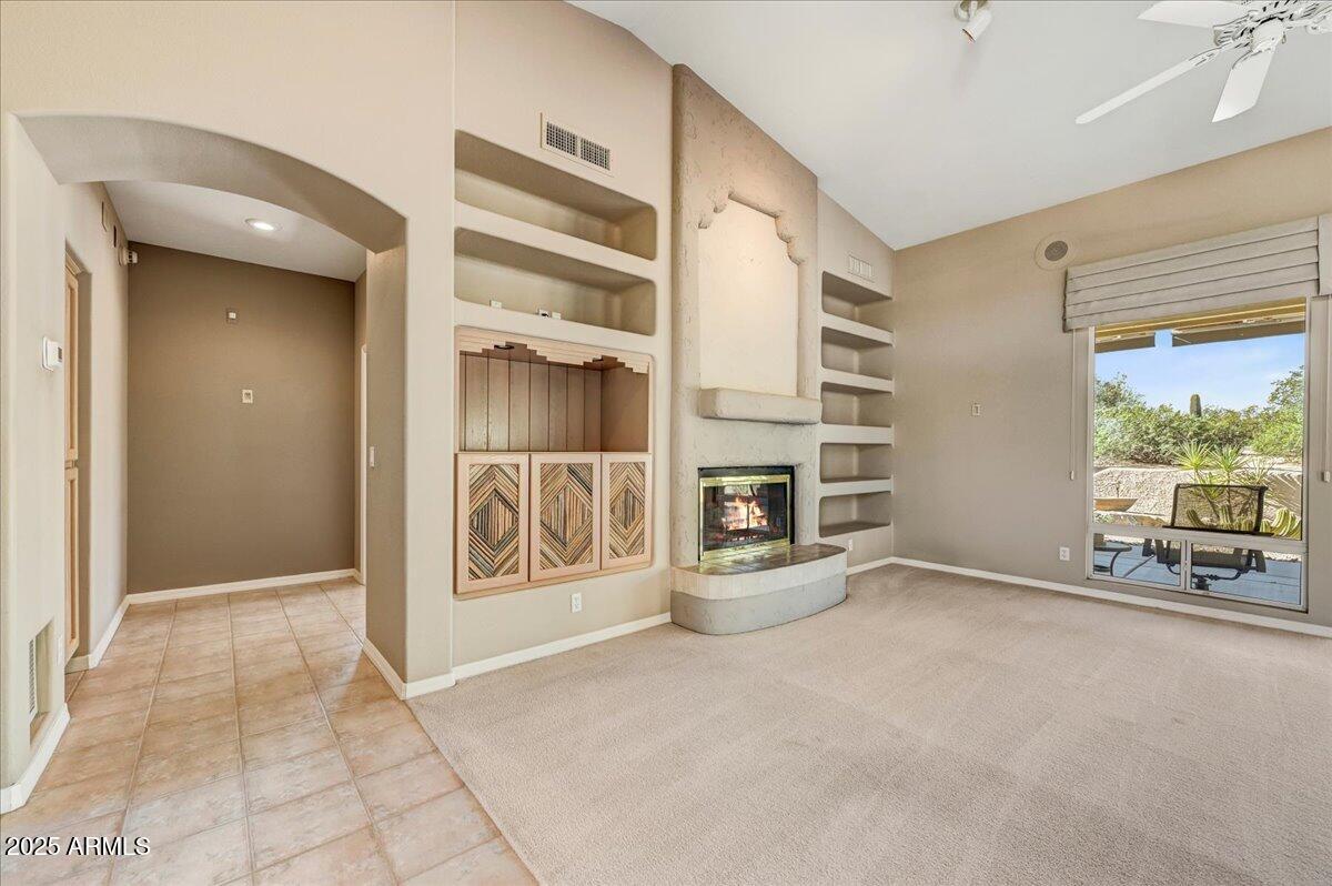 27002 North Agua Verde Drive Rio Verde, AZ 85263 - Photo 10 of 28 a view of an empty room with a fireplace and a window