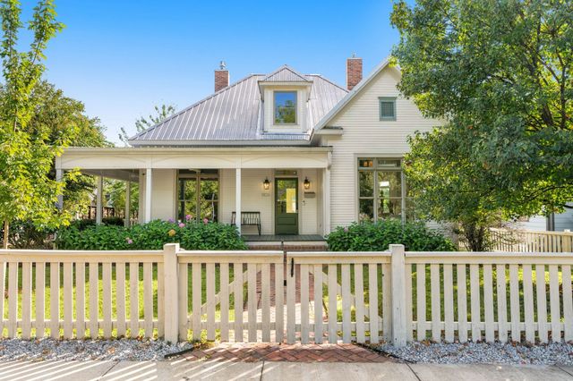 a view of a house with a wooden fence