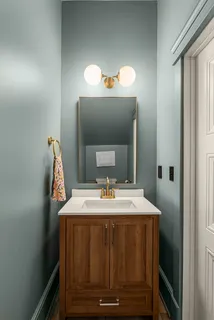 a view of a kitchen with kitchen island a sink stainless steel appliances counter space and a window