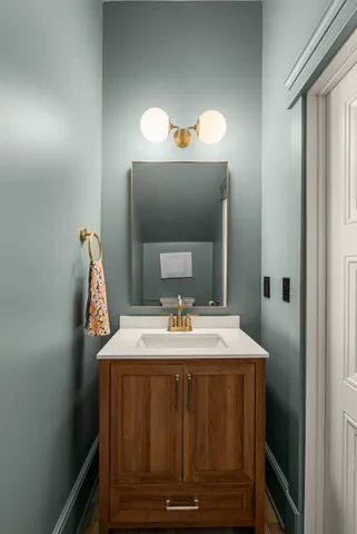 a view of a kitchen with kitchen island a sink stainless steel appliances counter space and a window