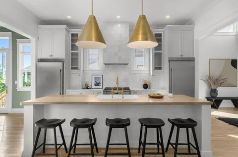 a table with a painting on wall and a potted plant