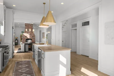 a living room with furniture and large windows