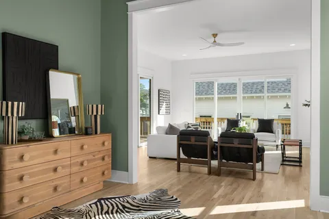 a living room with furniture and a wooden floor