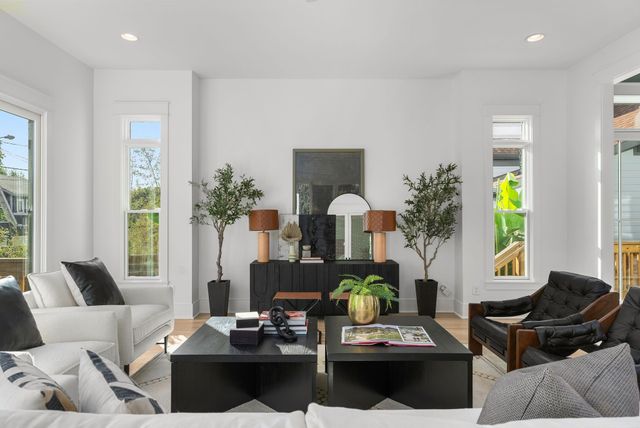 a bathroom with a granite countertop sink a toilet and shower