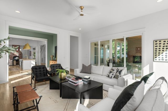 a view of a livingroom with wooden floor and staircase