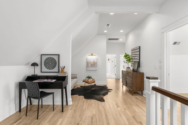 a view of house with a yard and sitting area