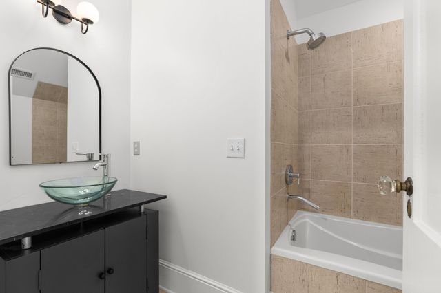 a bedroom with furniture and a chandelier