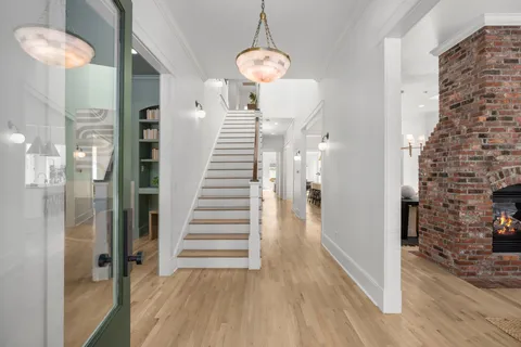 a view of a dining room with furniture and chandelier