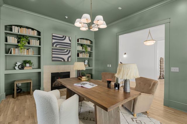 a living room with furniture a chandelier and a dining room