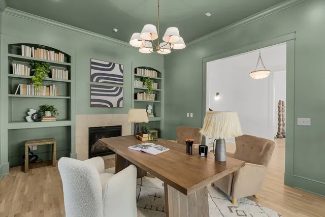 a living room with furniture a chandelier and a dining room
