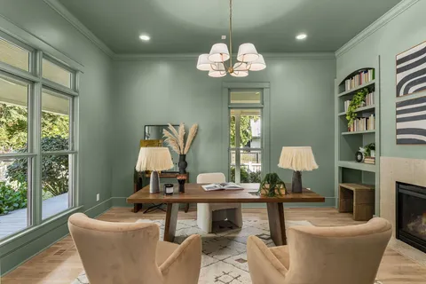 a living room with furniture chandelier and a window