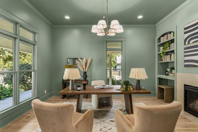a living room with furniture chandelier and a window