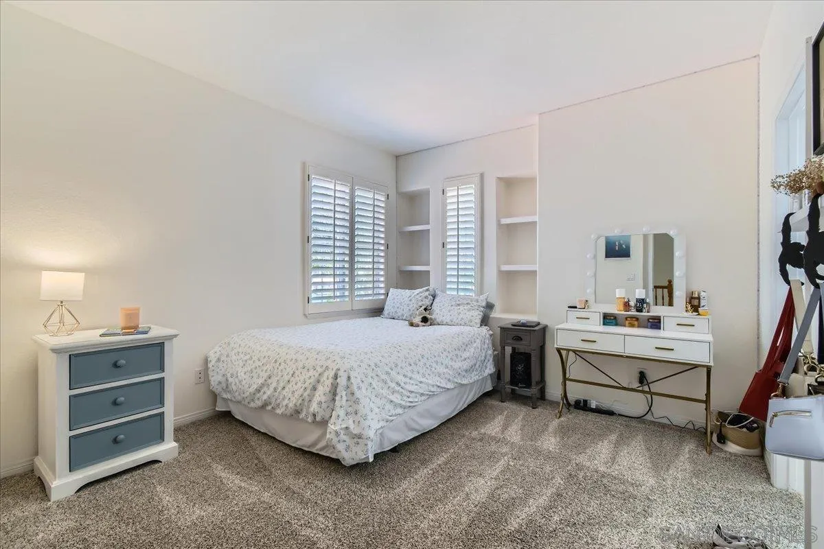 1382 Sparrow Road Carlsbad, CA 92011 - Photo 14 of 34 a bedroom with a bed and a desk