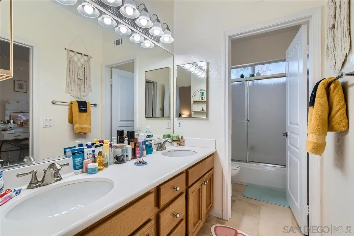 1382 Sparrow Road Carlsbad, CA 92011 - Photo 17 of 34 a bathroom with a sink a vanity and a mirror
