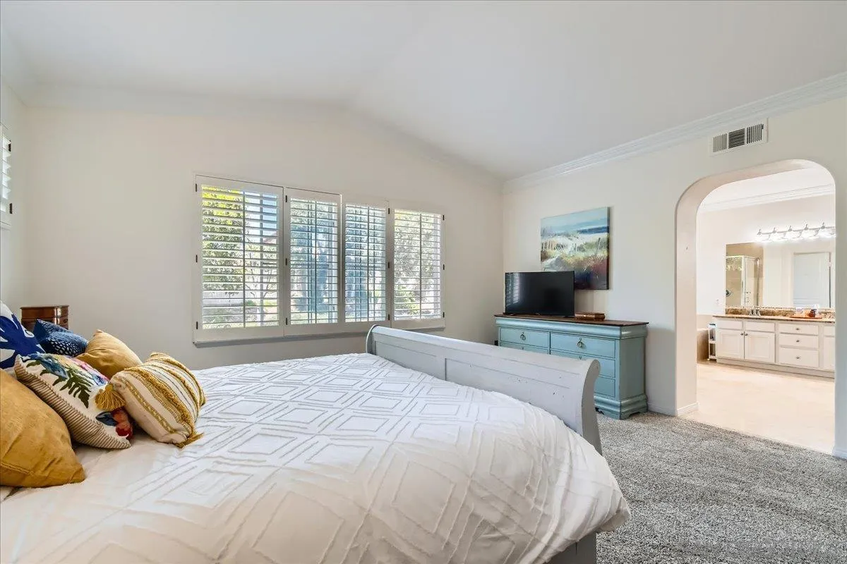 1382 Sparrow Road Carlsbad, CA 92011 - Photo 25 of 34 a bedroom with a large bed and a television
