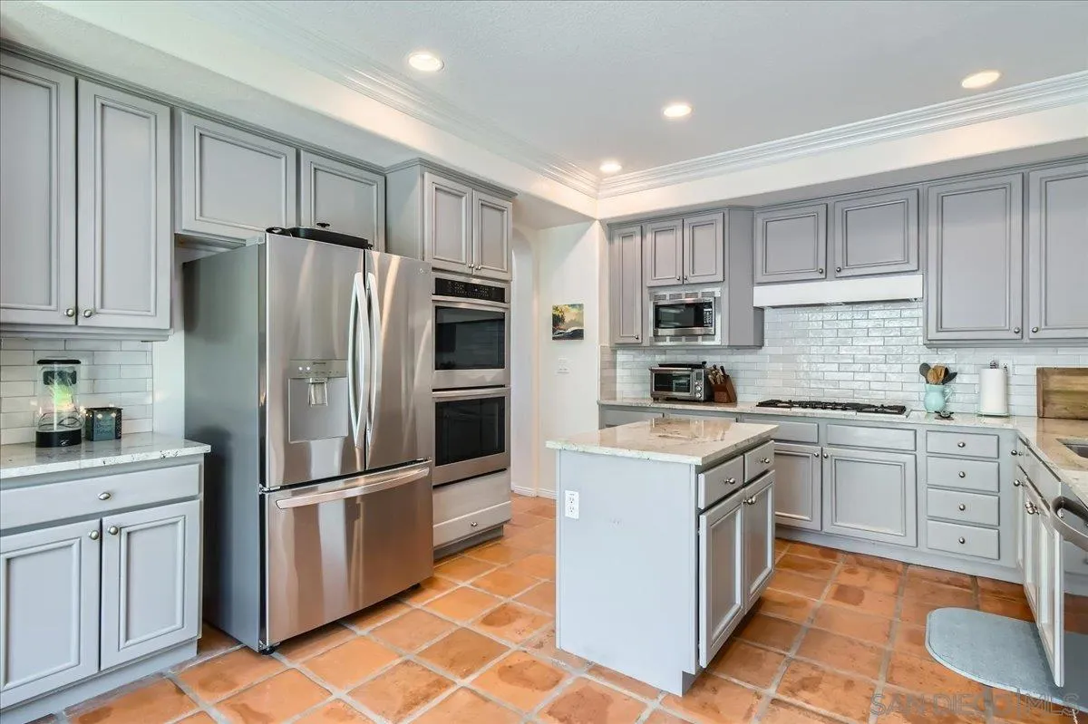 1382 Sparrow Road Carlsbad, CA 92011 - Photo 8 of 34 a kitchen with cabinets stainless steel appliances and a counter space