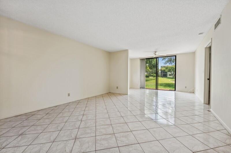 15074 Witney Road, Unit C101 Delray Beach, FL 33484 - Photo 3 of 25 03_15074WitneyRd_Unit101_1_LivingRoom_Fl
