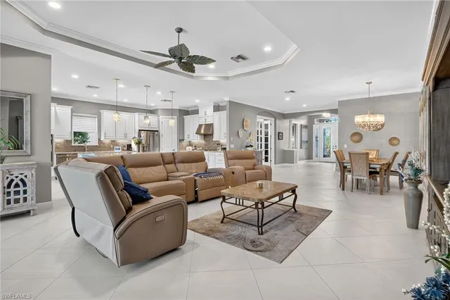 a living room with stainless steel appliances kitchen island granite countertop furniture and a view of kitchen