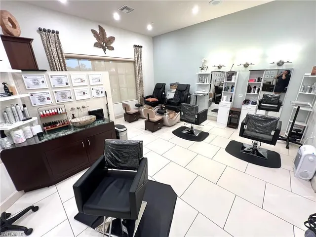 a kitchen with a table chairs and white cabinets