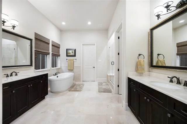 a spacious bathroom with a double vanity sink mirror double and bathtub
