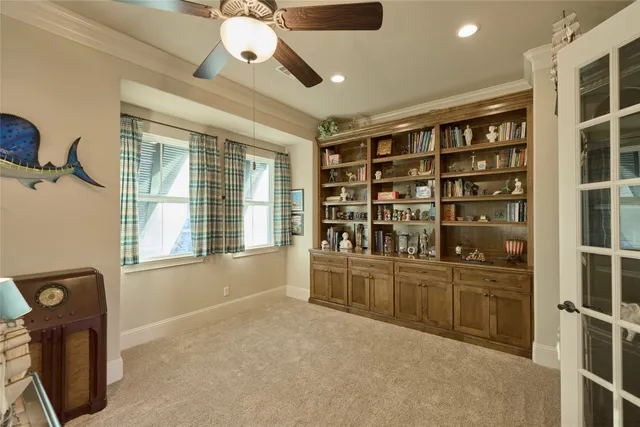 a view of an empty room with a window and cabinet