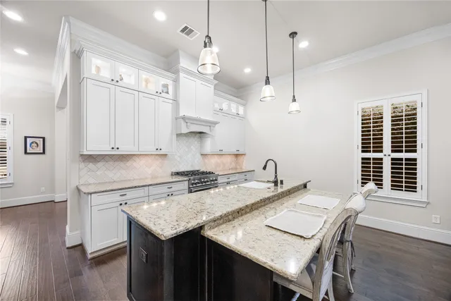a kitchen with a table chairs and wooden floor