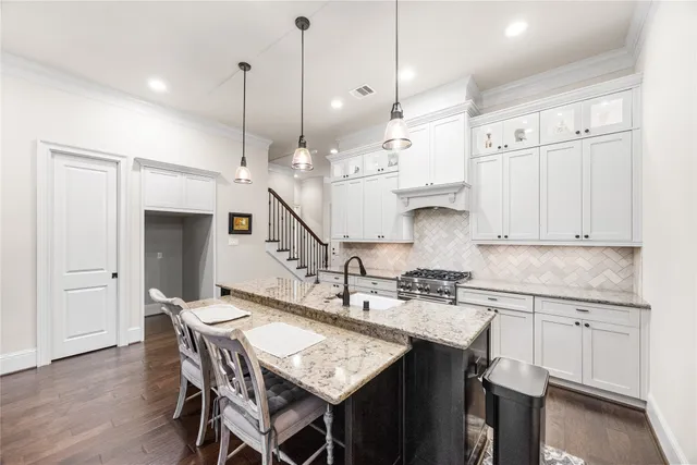 a kitchen with stainless steel appliances kitchen island a chandelier